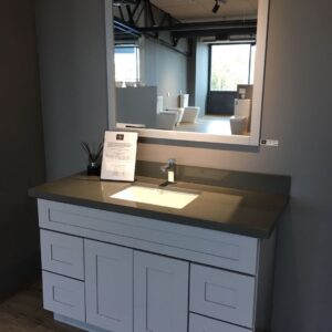 Modern bathroom vanity with single basin and large mirror.