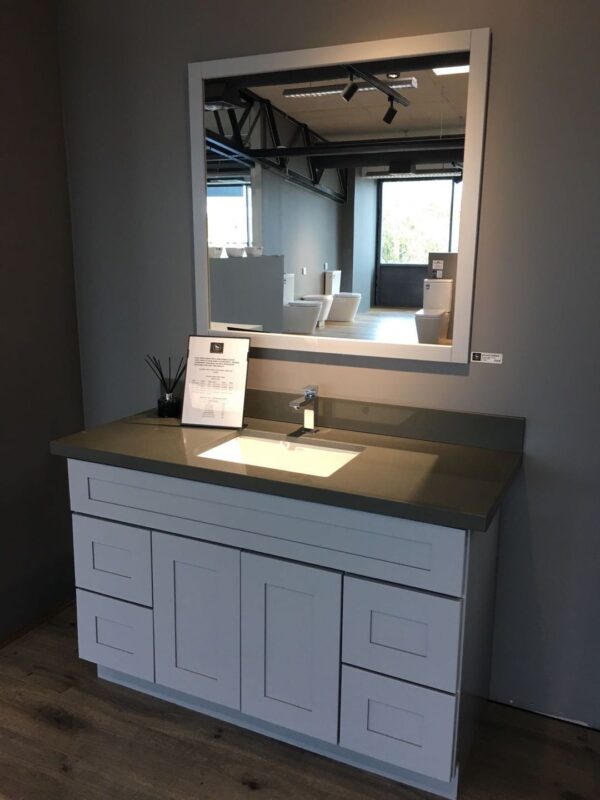 Modern bathroom vanity with single basin and large mirror.