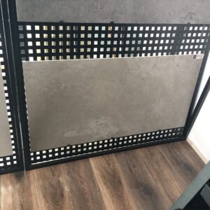 Tile display on wooden floor in showroom.