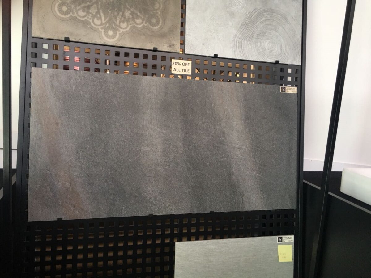 Display of various tiles with a 20% off sign.