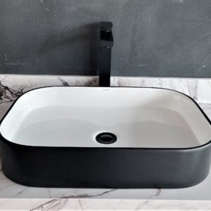 Modern black and white rectangular bathroom sink with marble countertop.