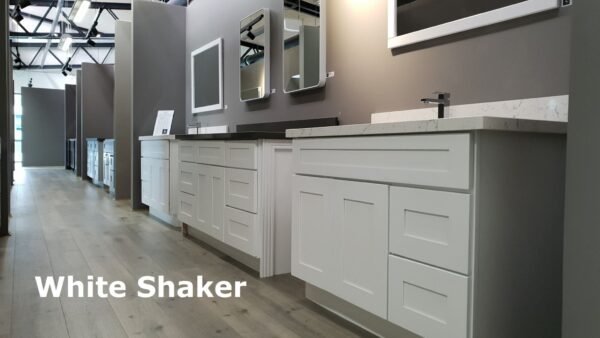 White Shaker kitchen cabinets displayed in a showroom.