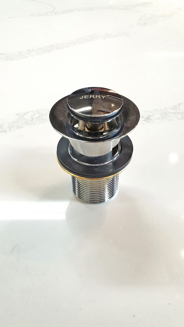 Chrome sink drain plug on white surface.