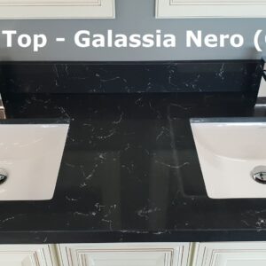 Black vanity top with two sinks and modern faucets.