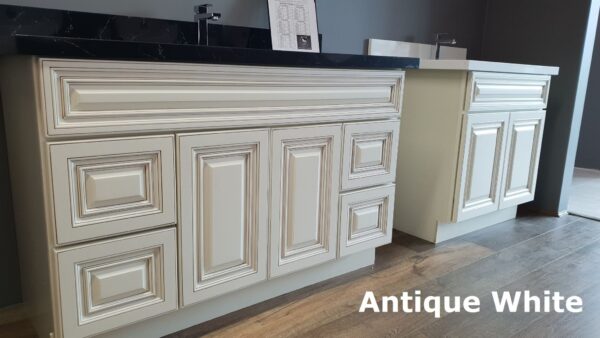 Antique-style kitchen cabinets with intricate detailing and dark countertop.