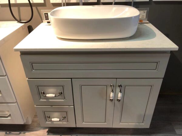 20220318135110.jpg White bathroom vanity with drawers and a countertop sink.