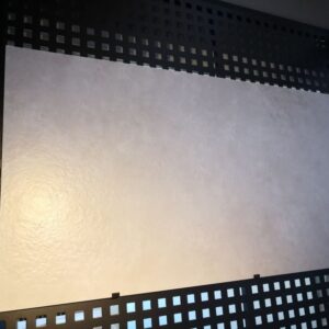 Textured wall panel with decorative grid design.