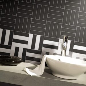 Modern bathroom with geometric black and white tile design.
