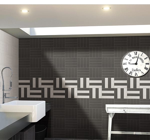 Modern bathroom with geometric black and white tile design.