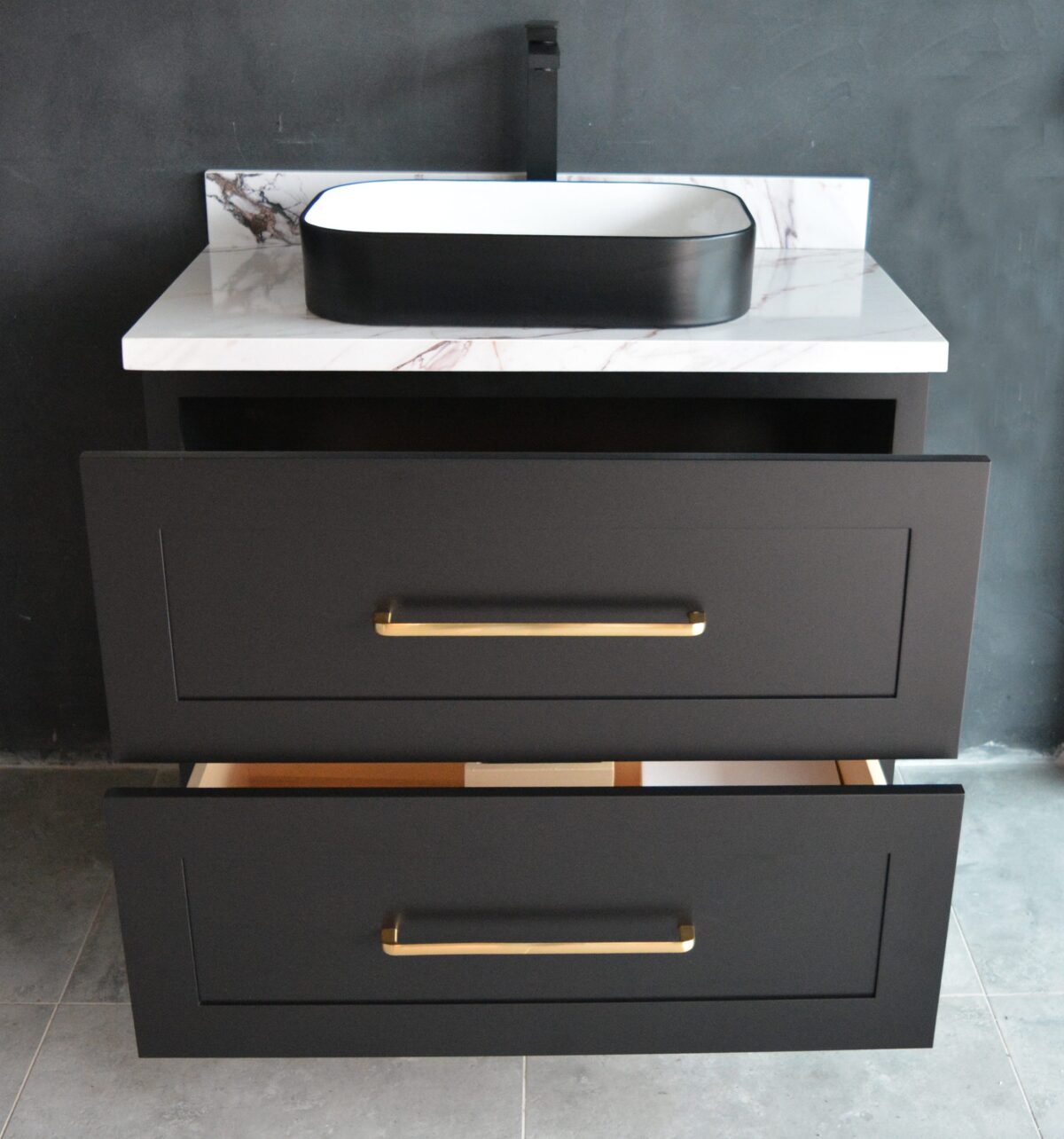 Black freestanding vanity with open drawers and modern sink.