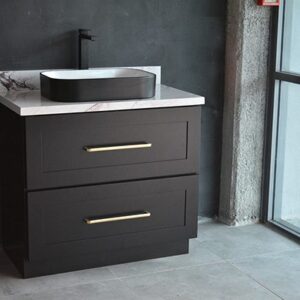 Black freestanding vanity with marble countertop and modern sink.