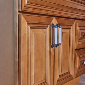 Wooden kitchen cabinet with detailed paneling and modern handles.