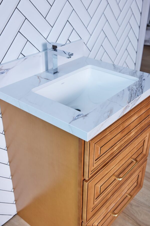 Wooden bathroom vanity with marble countertop and modern faucet.