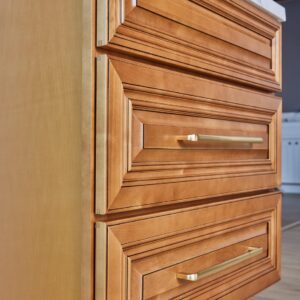 Wooden kitchen cabinet with brass handles.