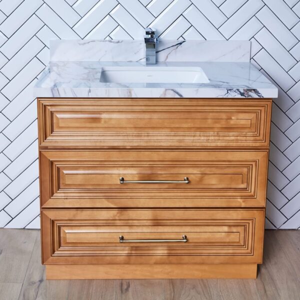 COG-VDB3620-32.5-1.jpg Wooden bathroom vanity with marble countertop and herringbone tile backsplash.