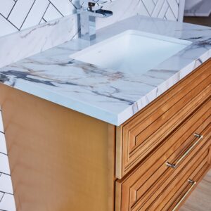 Wooden bathroom vanity with marble countertop and modern faucet.
