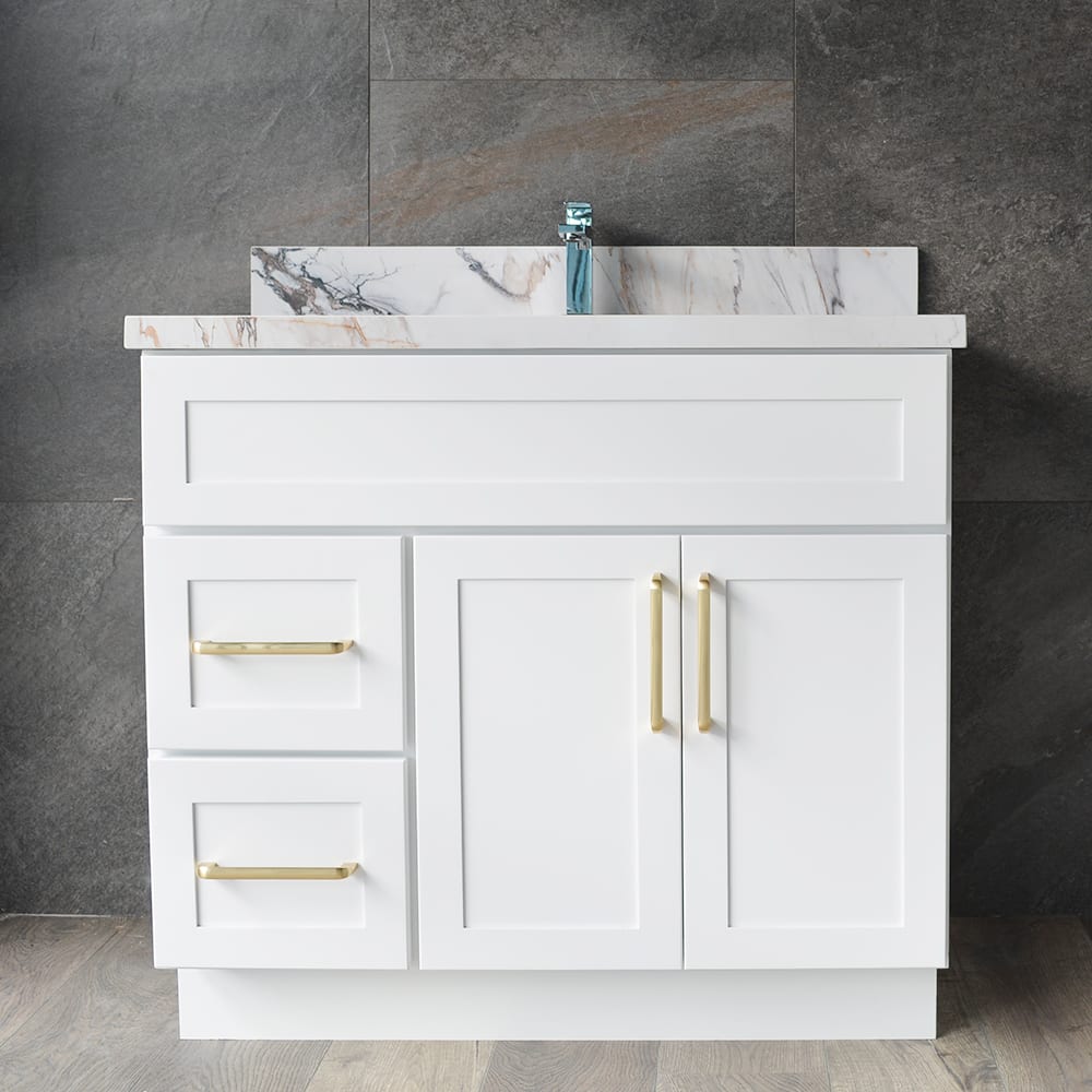 White bathroom vanity with marble countertop and gold handles.