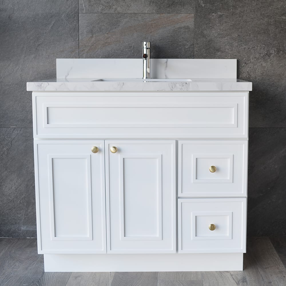 White bathroom vanity with marble countertop and gold knobs.