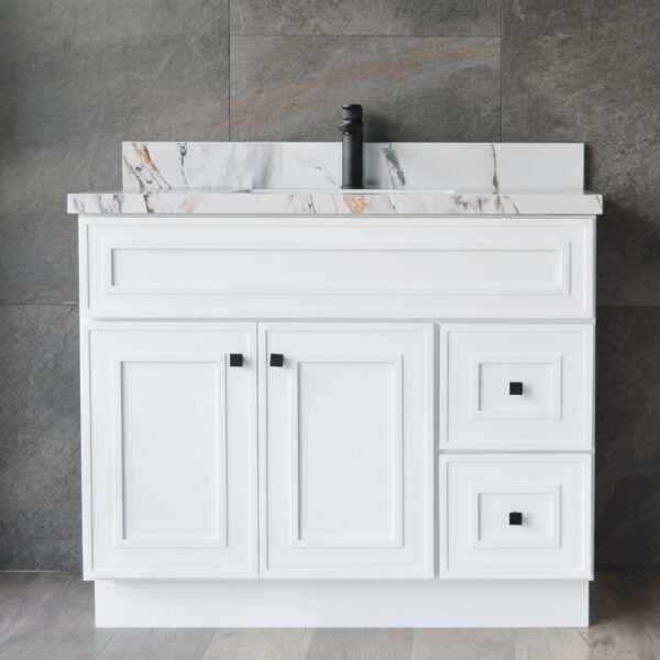 White bathroom vanity with marble countertop and black faucet.