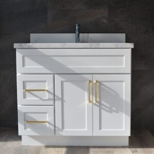 White bathroom vanity with gold handles and marble countertop.