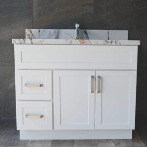 White bathroom vanity with marble countertop and modern faucet.