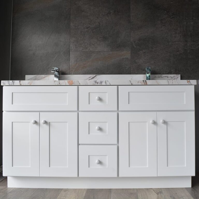 White bathroom vanity with marble countertop and dual faucets.