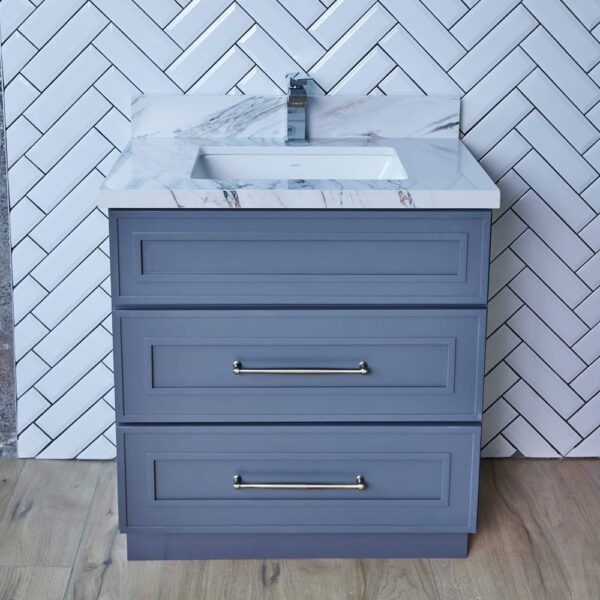 ESDG-VDB3020-32.5-1.jpg Gray bathroom vanity with marble countertop and herringbone tile backsplash.