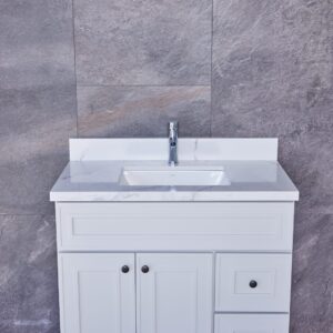 White bathroom vanity with marble countertop and gray tiled wall background.