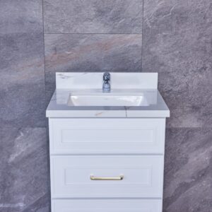 White bathroom vanity with marble countertop against gray tiled wall.