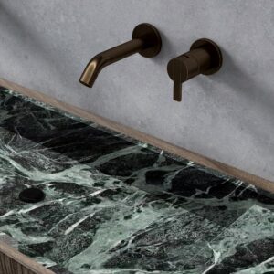 Emerald green sintered stone bench with bronze faucet.