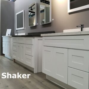 White shaker-style kitchen cabinets with mirrors above.