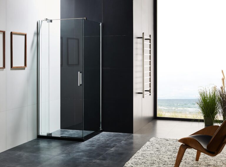 Modern bathroom with glass shower enclosure and ocean view.
