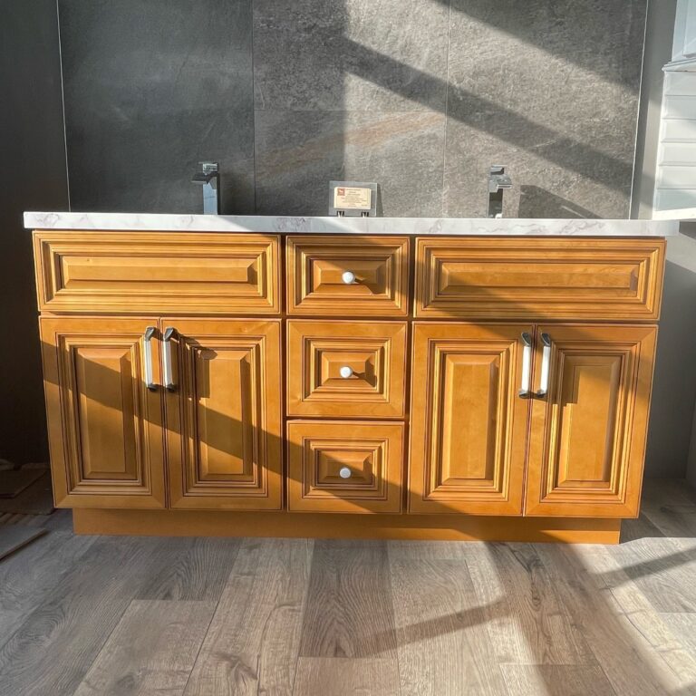 Wooden kitchen cabinet with marble countertop in sunlight.