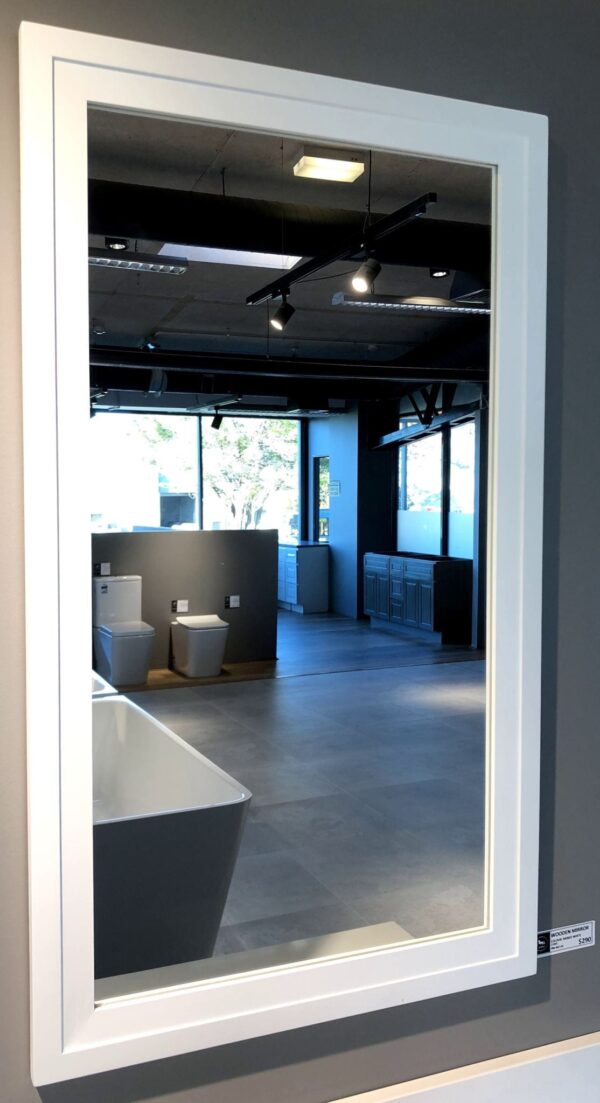 Showroom with bathroom fixtures and large wall mirror.
