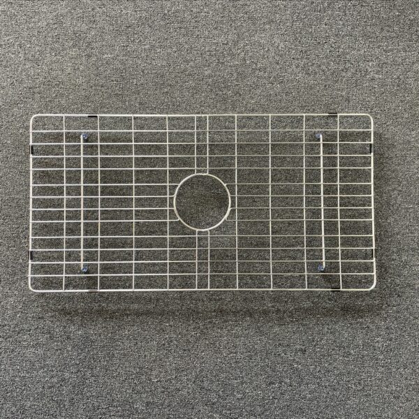 SingleL-1-scaled-2.jpg Stainless steel sink grid on a textured surface.