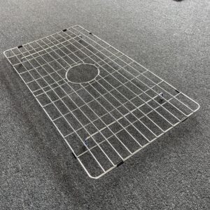 Stainless steel sink grid on gray carpet.