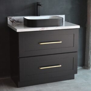 Black bathroom vanity with marble countertop and modern faucet.