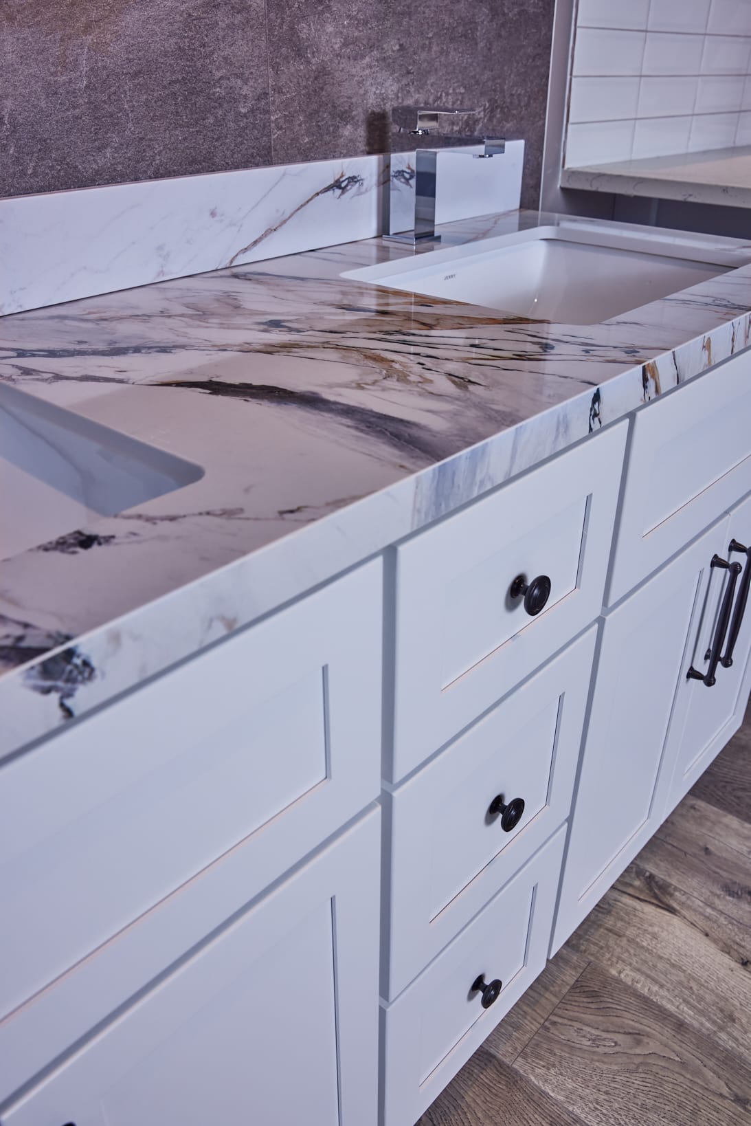 Marble countertop with white cabinets in modern kitchen.
