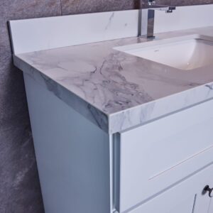 Modern bathroom vanity with marble countertop and sleek faucet.