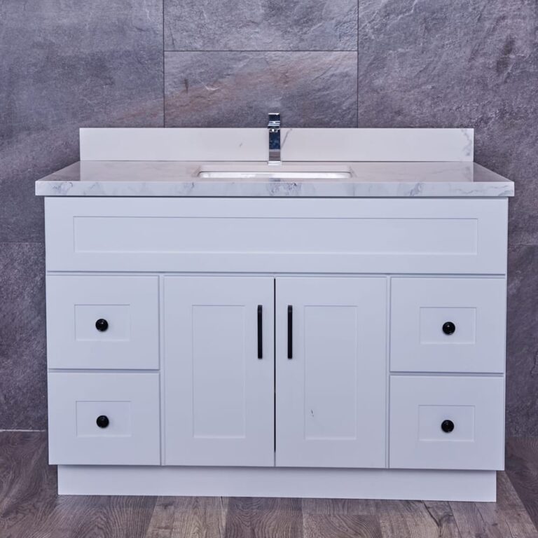 White bathroom vanity with marble countertop and sink.