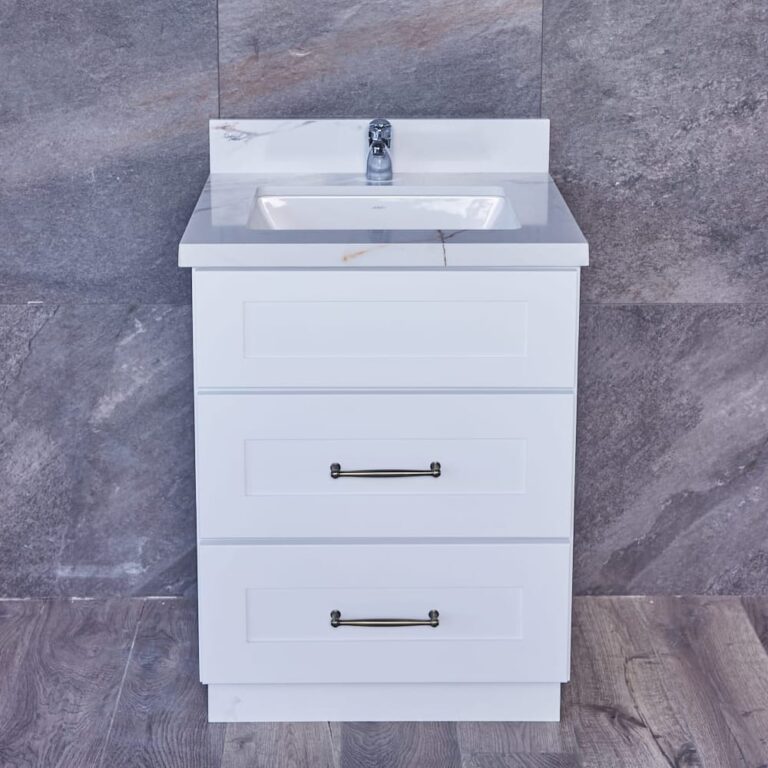 White bathroom vanity with three drawers and a marble countertop.
