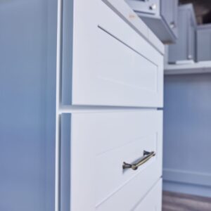 White kitchen cabinet with silver handle in modern kitchen.