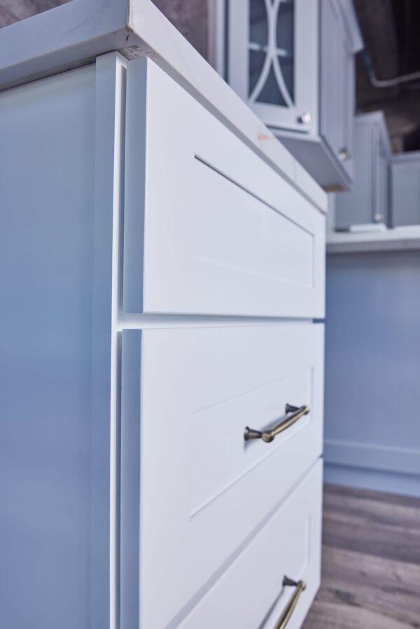 White kitchen cabinet with silver handle in modern kitchen.