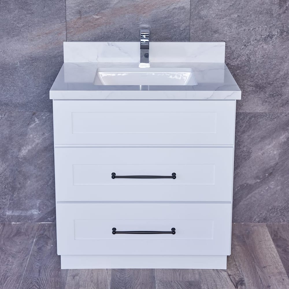 White bathroom vanity with marble countertop and modern faucet.