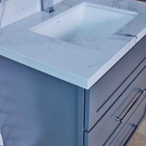 Modern bathroom vanity with marble countertop and sleek faucet.