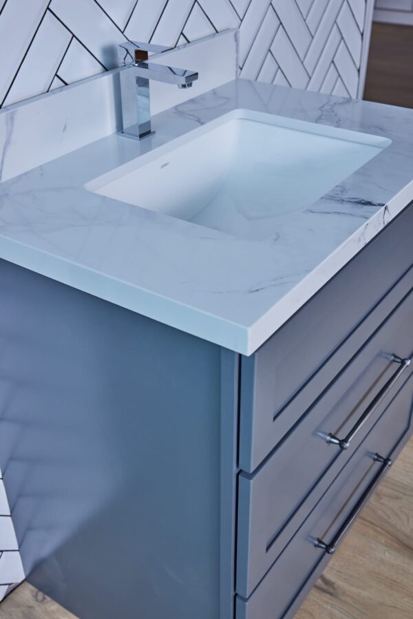 Modern bathroom vanity with marble countertop and sleek faucet.