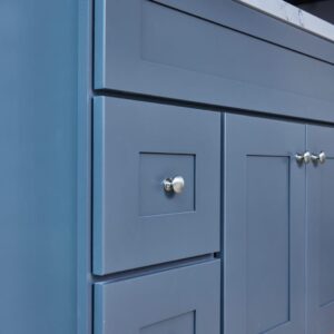 Blue kitchen cabinet with silver knobs.