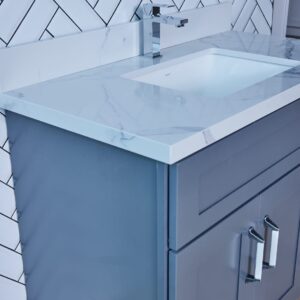 Blue bathroom vanity with marble countertop and modern faucet.