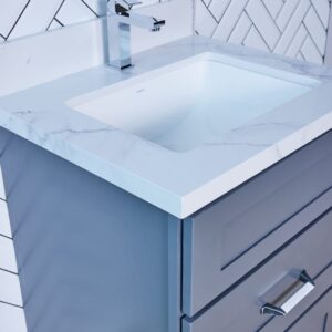 Modern bathroom vanity with marble countertop and herringbone tile backsplash.