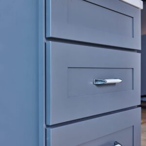 Blue kitchen cabinet with silver handle.